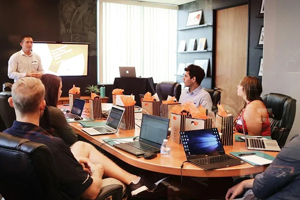 A team in an office discussing digital customer service during a meeting